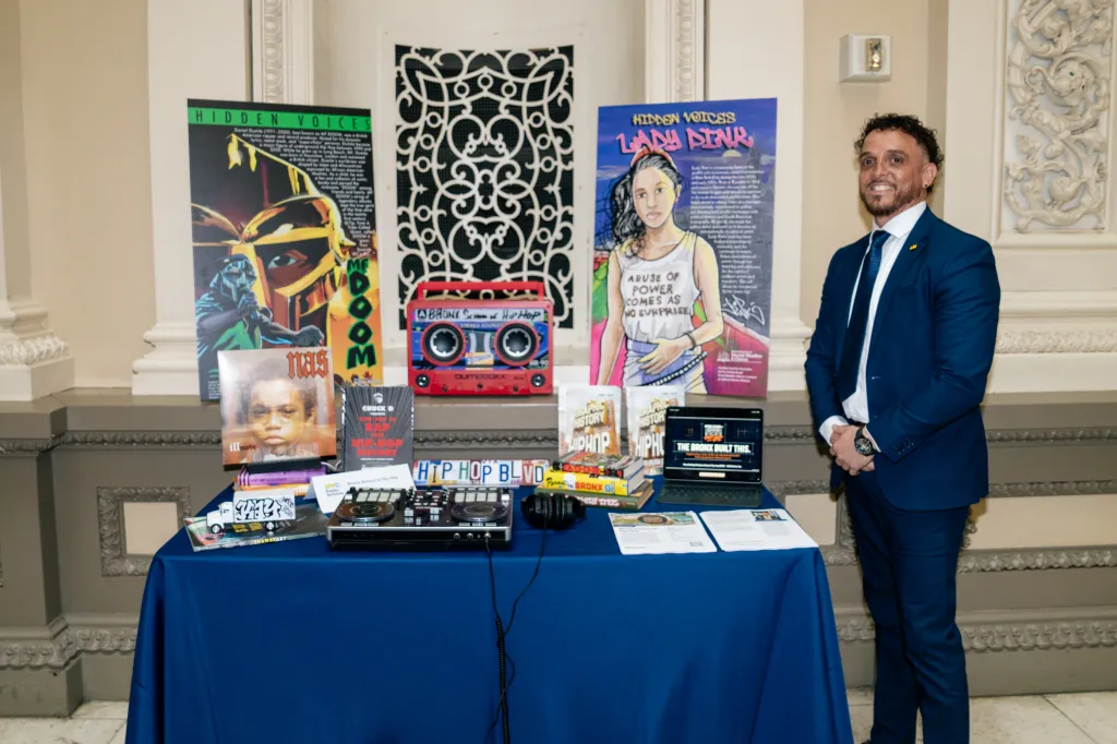 Jason Reyes next to a booth.