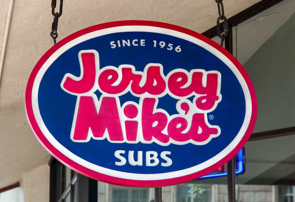 A hanging, oval sign for Jersey Mike's Subs, with