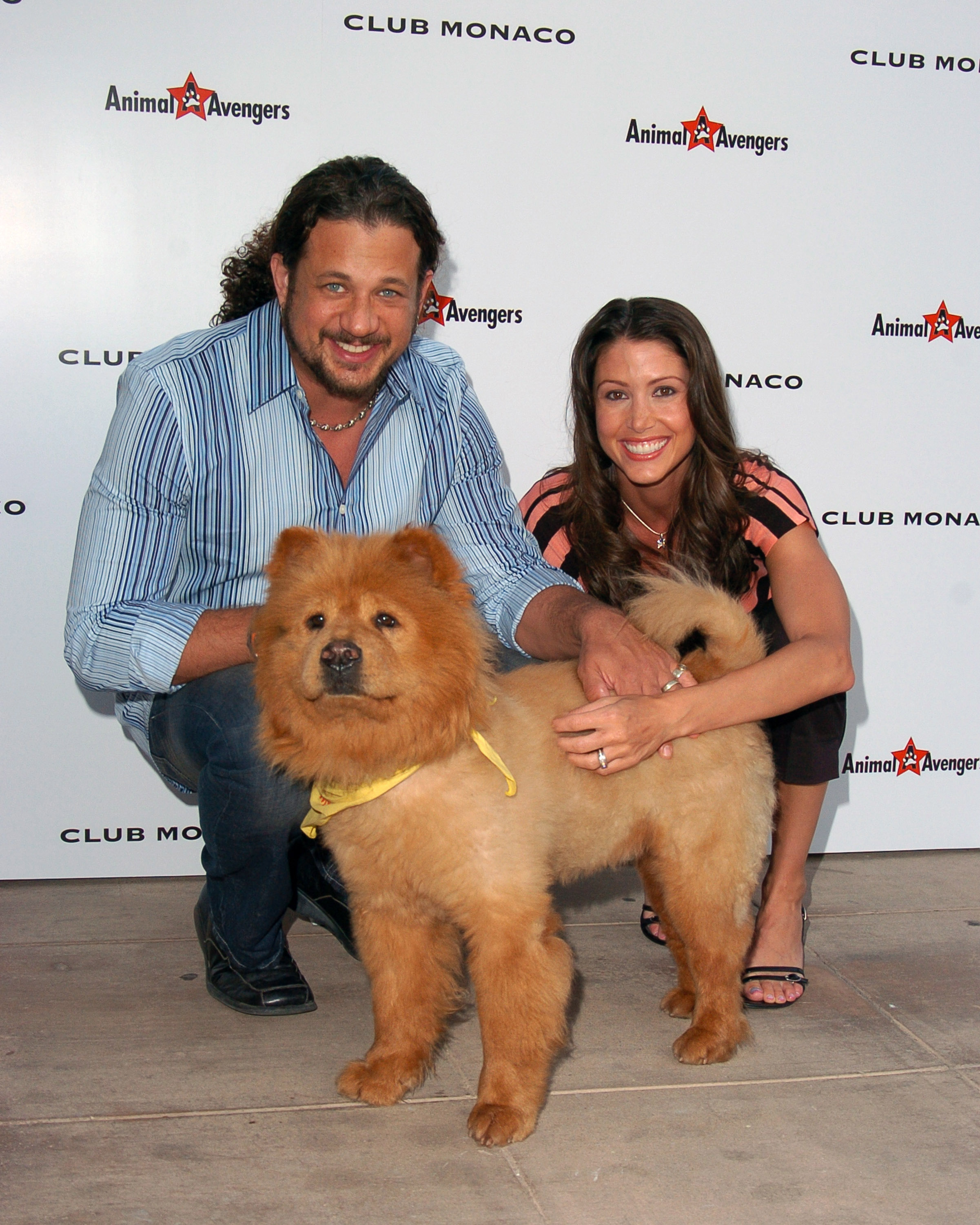 Joe Reitman and Shannon Elizabeth posing with a Chow Chow dog.