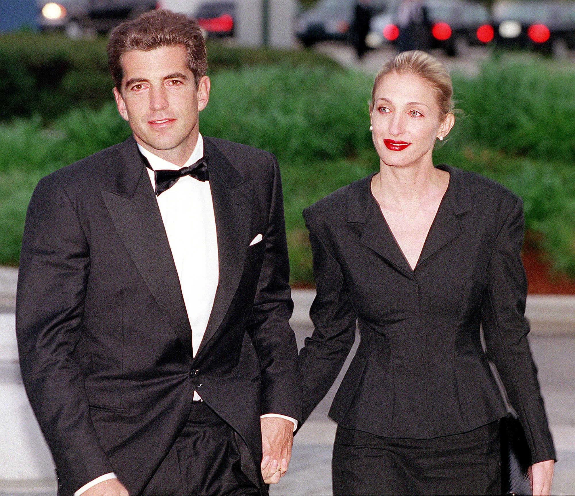 John F. Kennedy Jr. and Carolyn Bessette Kennedy walking hand-in-hand.