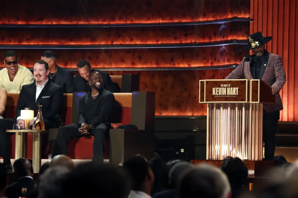 Katt Williams speaking at a podium during "The Roast of Kevin Hart" at the Netflix Is A Joke Festival.
