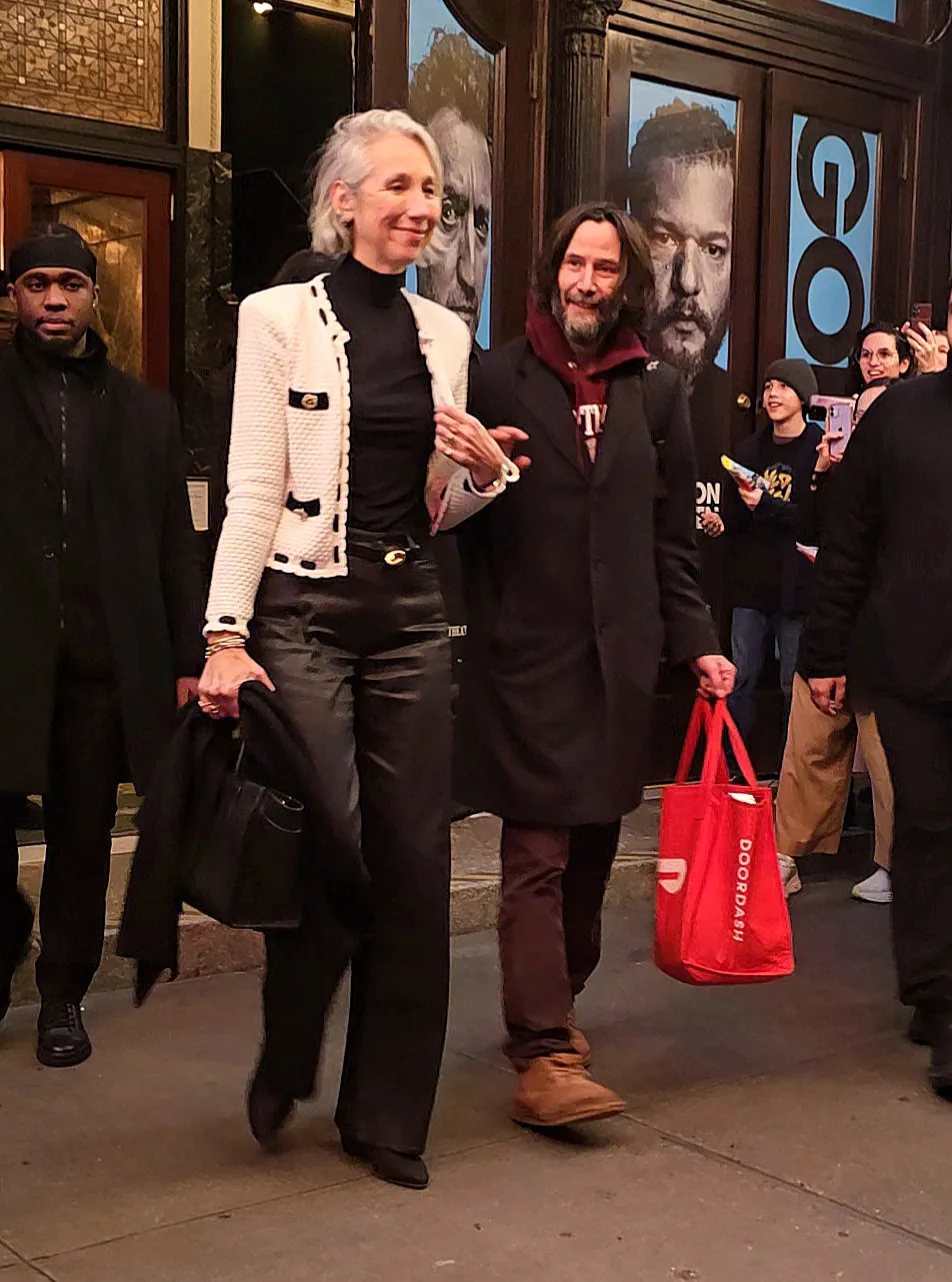 Alexandra Grant and Keanu Reeves walking hand-in-hand after a performance of "Waiting For Godot."