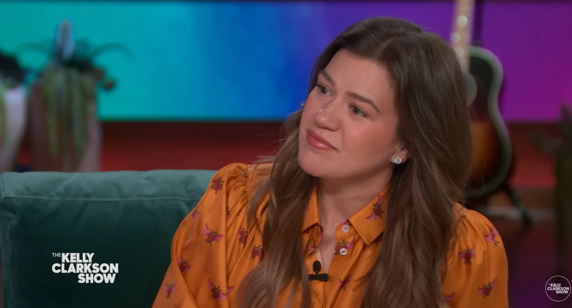Kelly Clarkson looks emotional during an interview.
