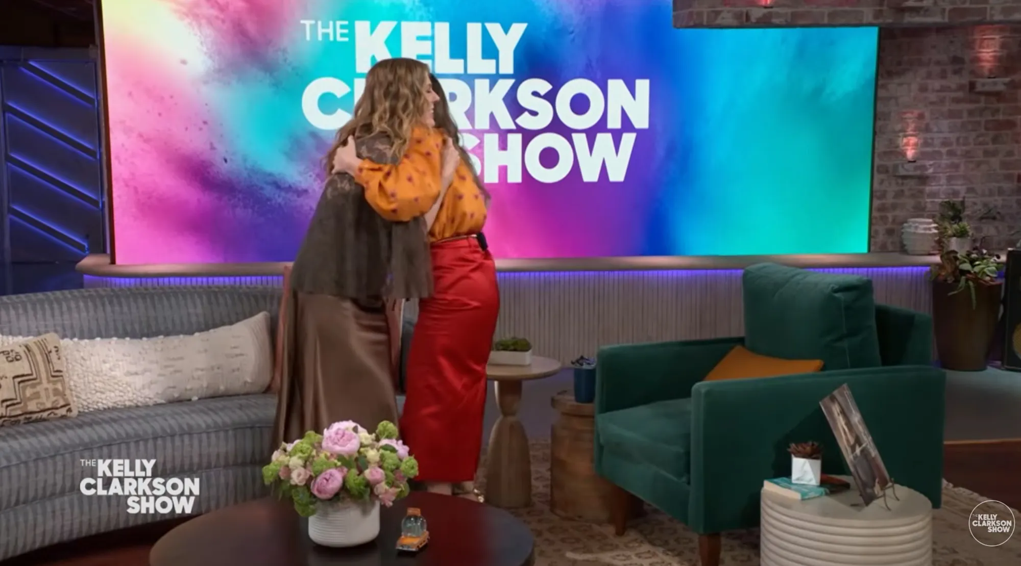 Kelly Clarkson hugging a guest on "The Kelly Clarkson Show" set.
