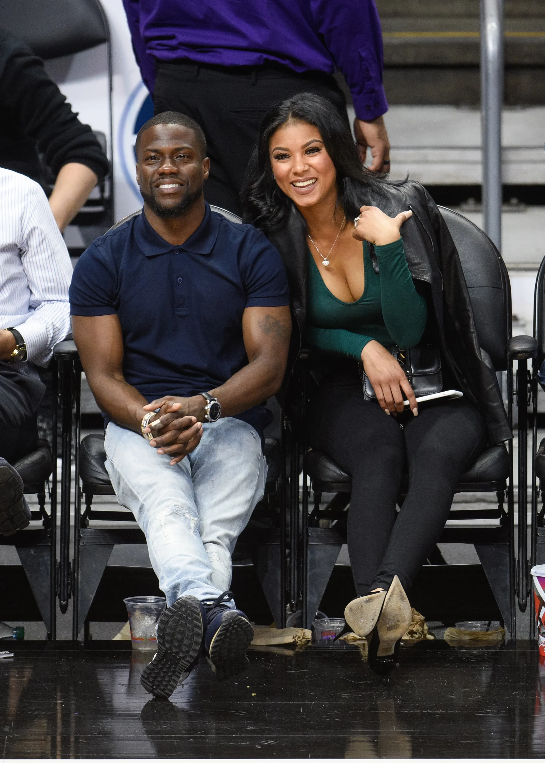 Kevin Hart and Eniko Parrish at a basketball game.