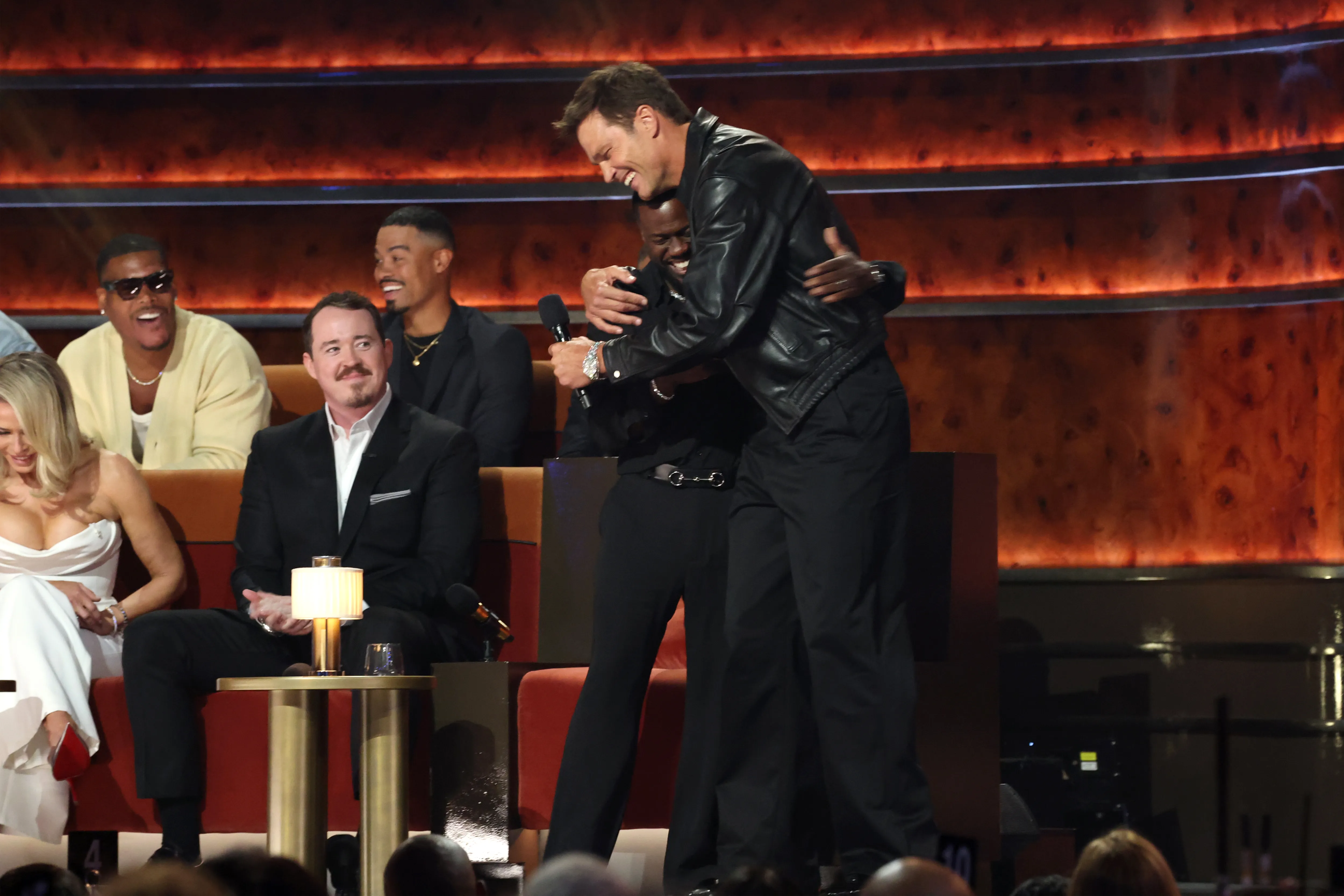 Tom Brady and Kevin Hart hug on stage during "The Roast of Kevin Hart" at the Netflix Is A Joke Festival.