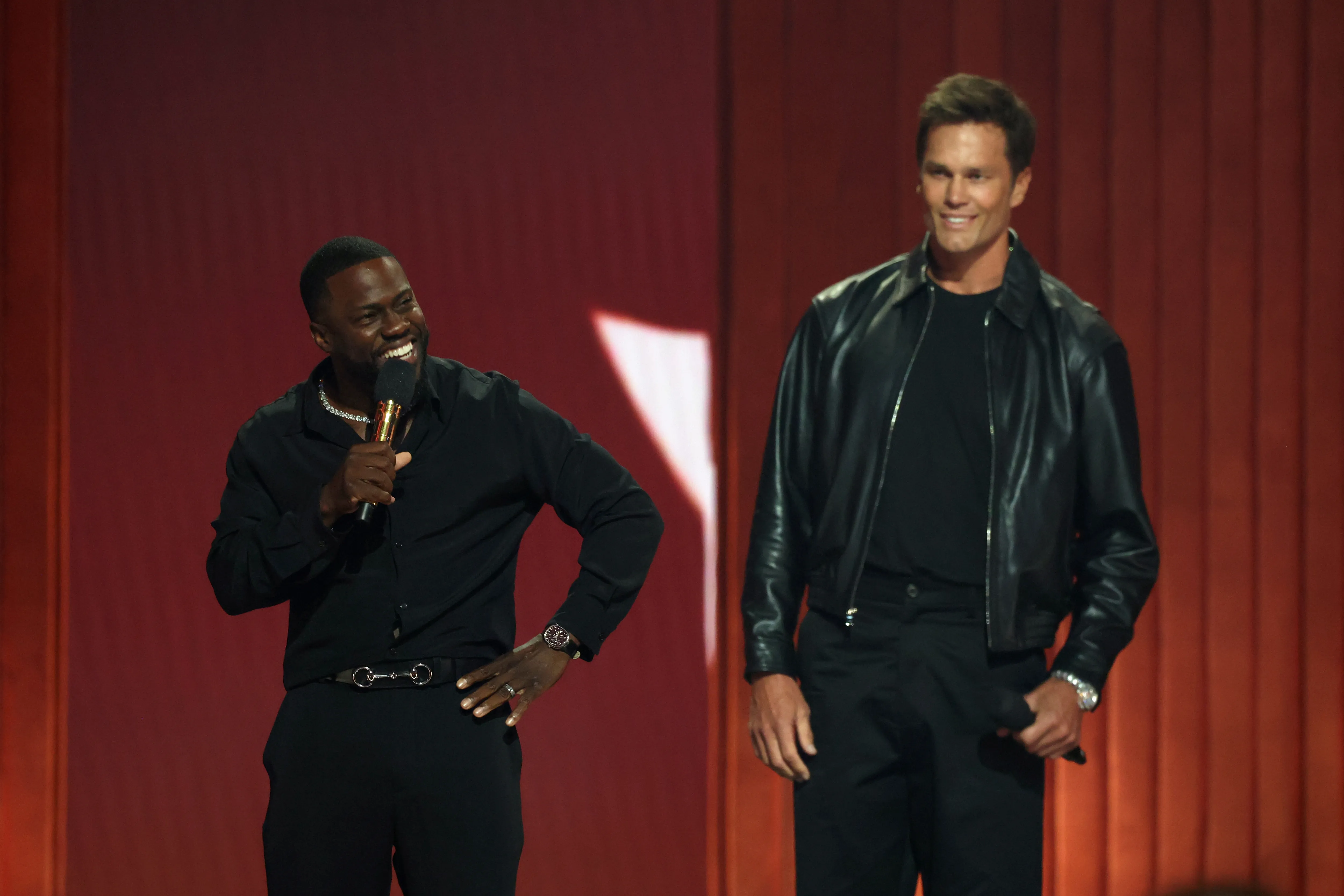 Kevin Hart and Tom Brady on stage during the Netflix Is A Joke Festival Presents: The Roast of Kevin Hart.