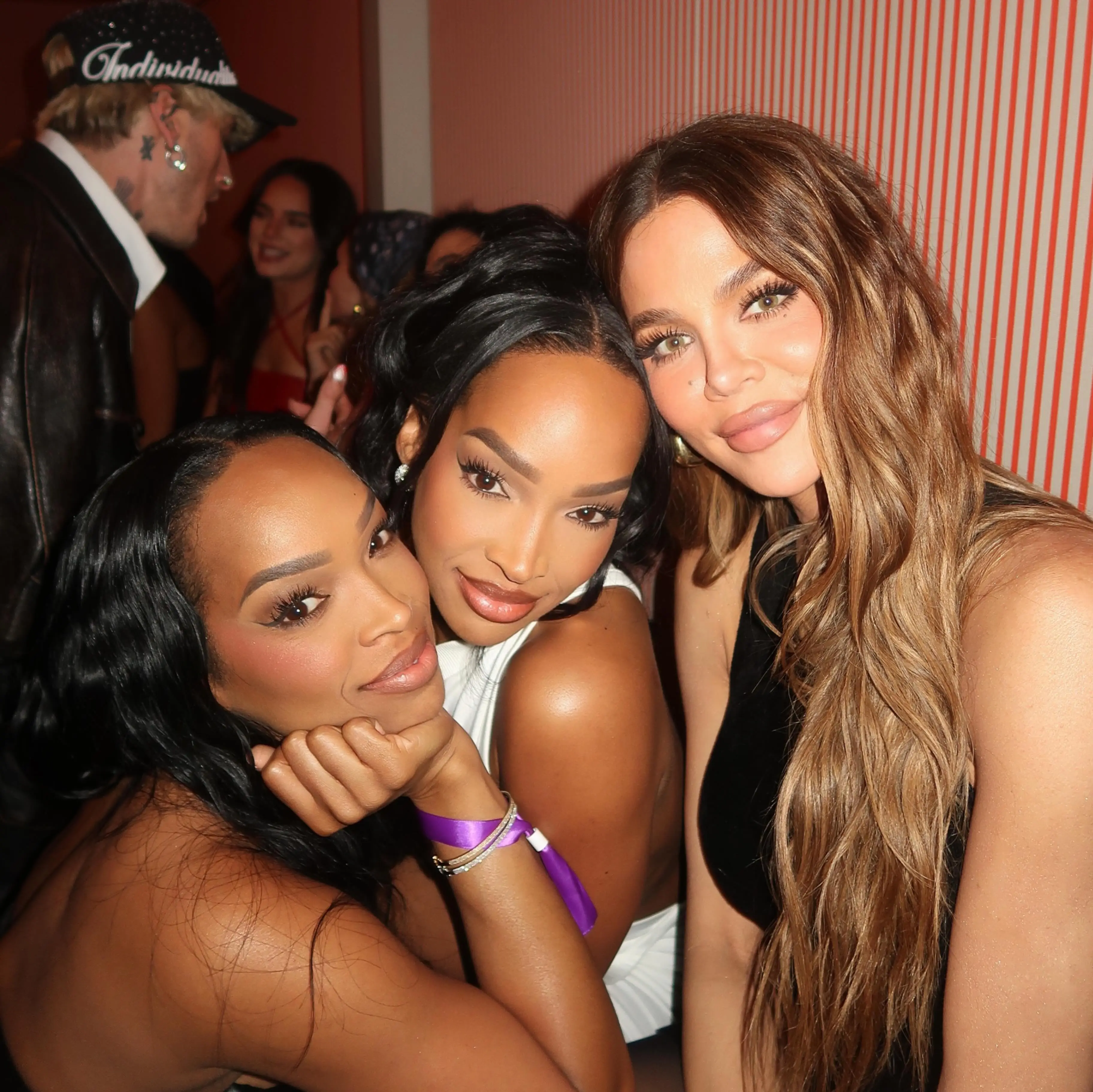 Khloe Kardashian and Malika Haqq pose with a friend on a night out.