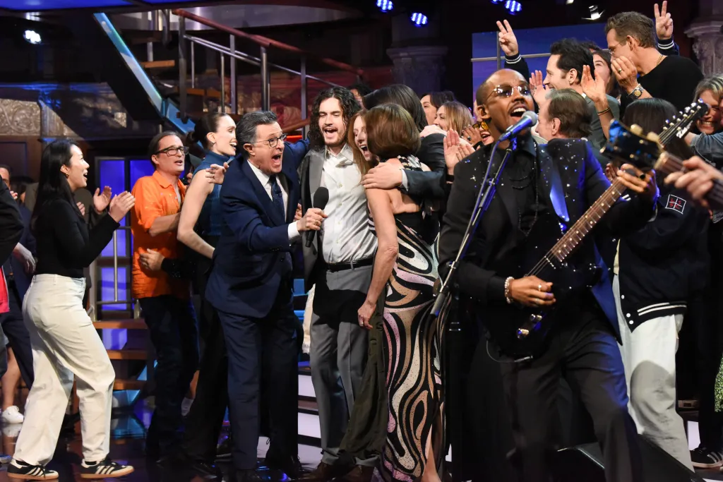 Stephen Colbert and a band performing on The Late Show.