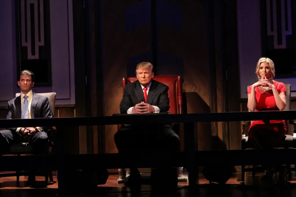 Donald Trump, Donald Trump Jr., and Ivanka Trump seated at a long table.