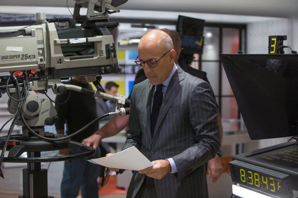 Matt Lauer reviewing papers while filming "Today."