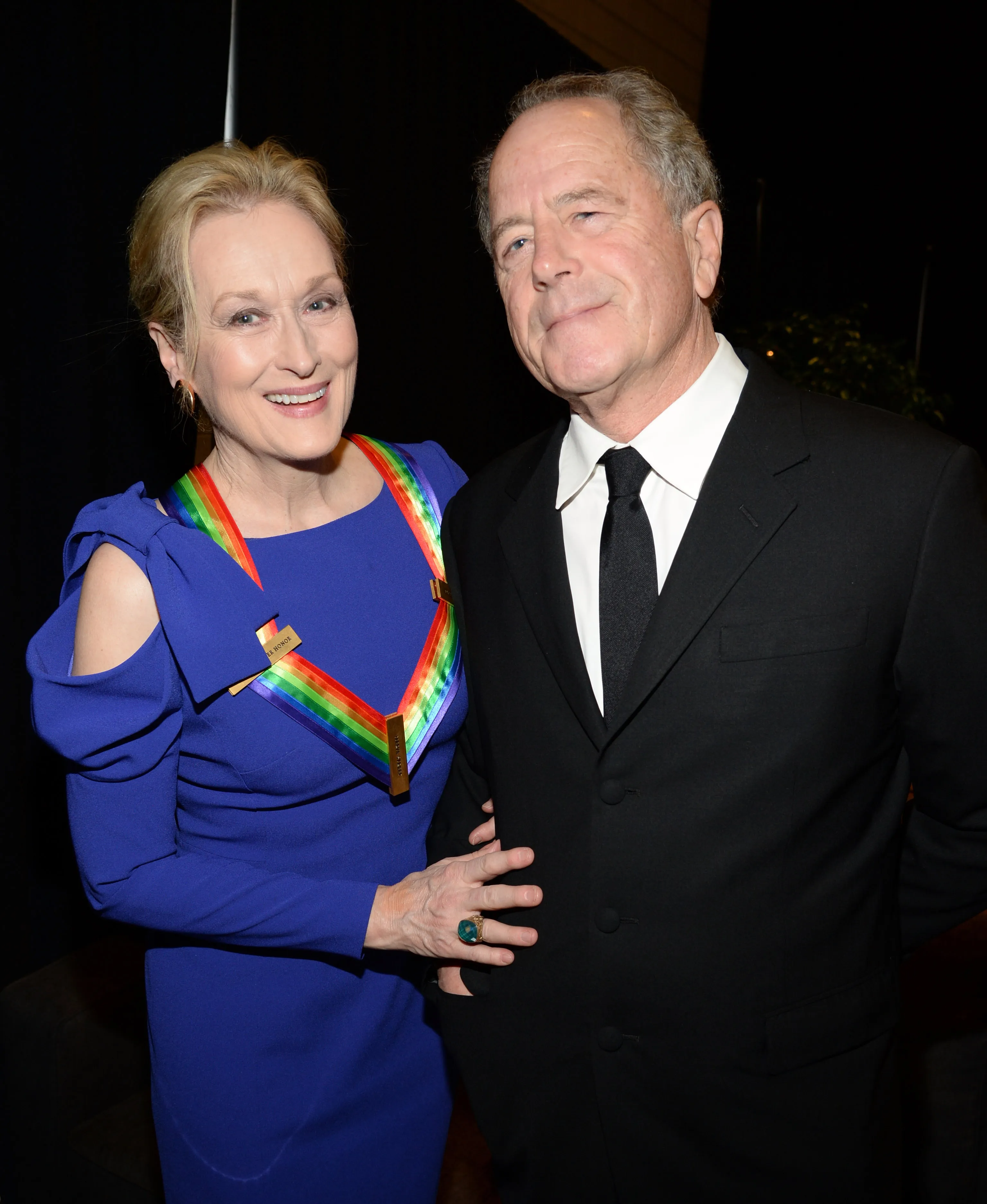 Meryl Streep, wearing a blue dress and a rainbow-colored medal, and Don Gummer, wearing a black suit, pose together at the 37th Annual Kennedy Center Honors.