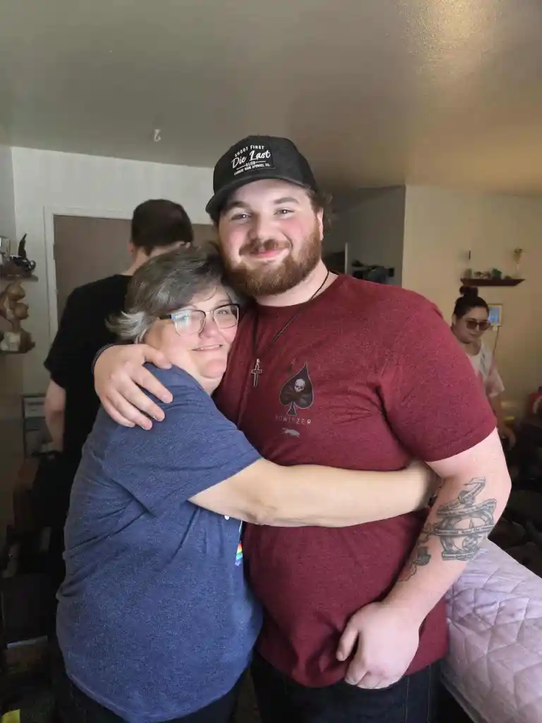 Michelle Lyson hugging a young man