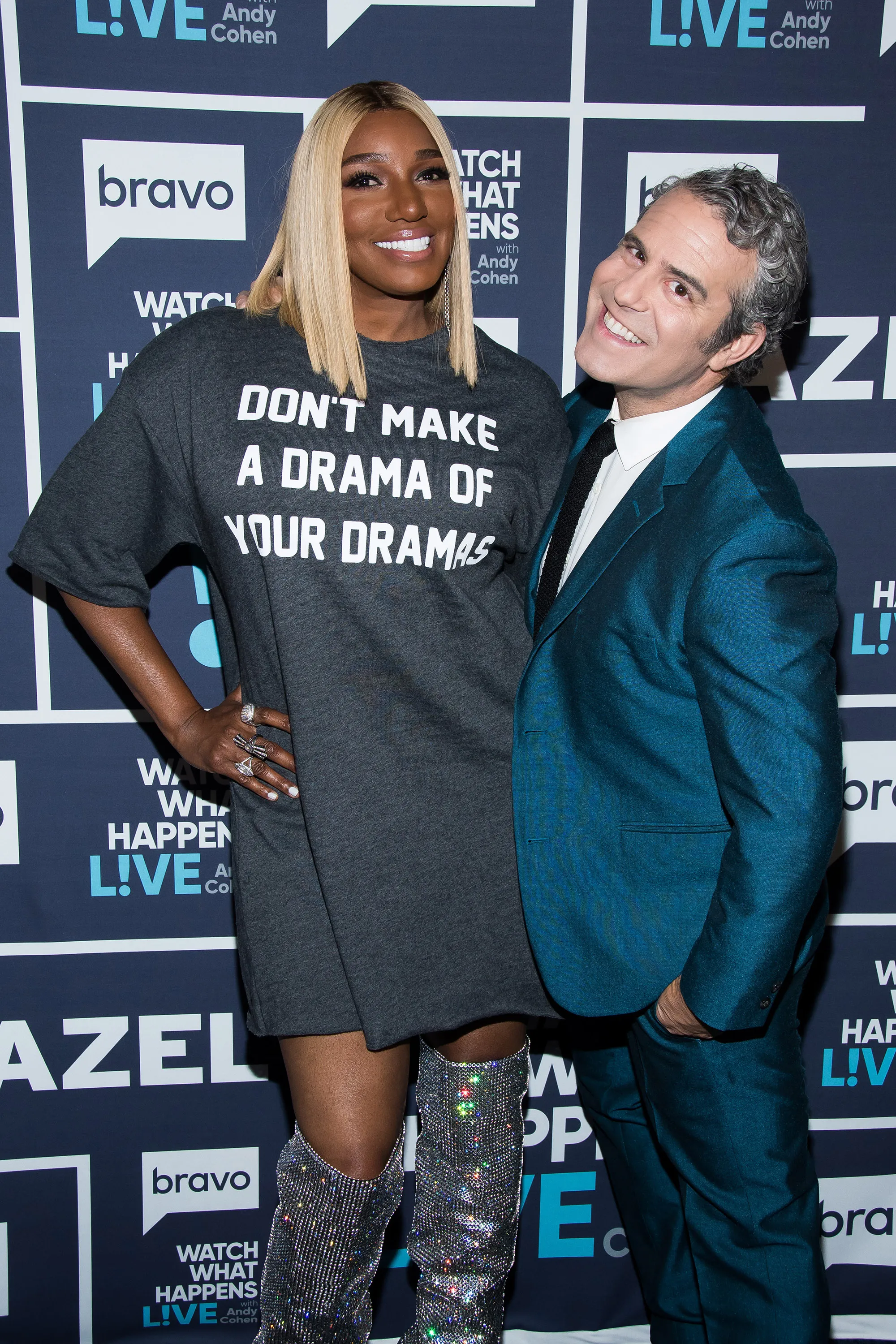 NeNe Leakes and Andy Cohen smiling for a photo, with Leakes wearing a grey shirt that reads 