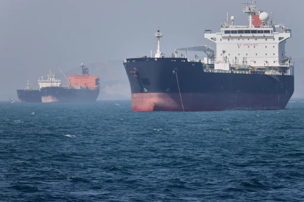 Tankers transit the Strait of Hormuz as markets react to signs of progress in high-stakes US-Iran talks.