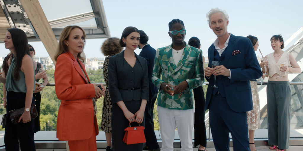 Philippine Leroy-Beaulieu as Sylvie Grateau, Lily Collins as Emily, Samuel Arnold as Julien, and Bruno Gouery as Luc at an outdoor event.