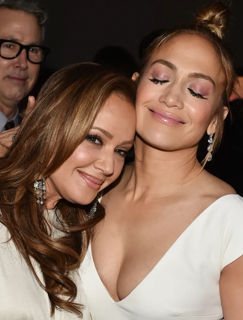 Leah Remini and Jennifer Lopez smiling and embracing.