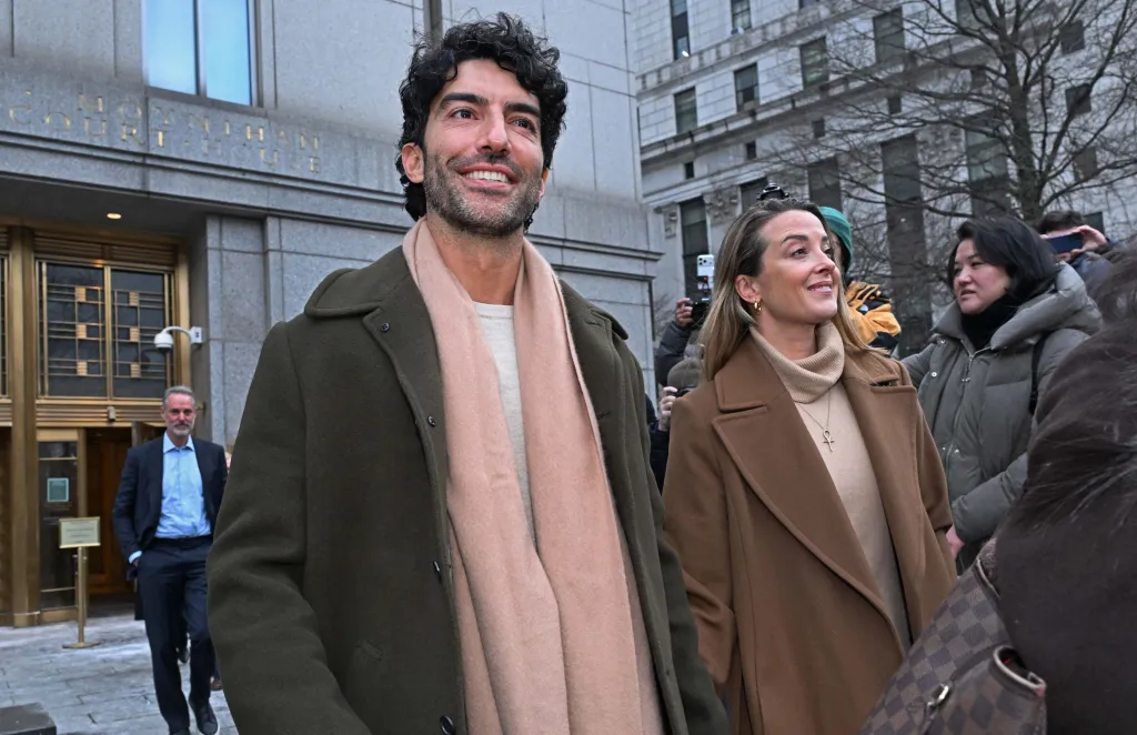 Justin Baldoni and a woman leave federal court after a settlement conference.