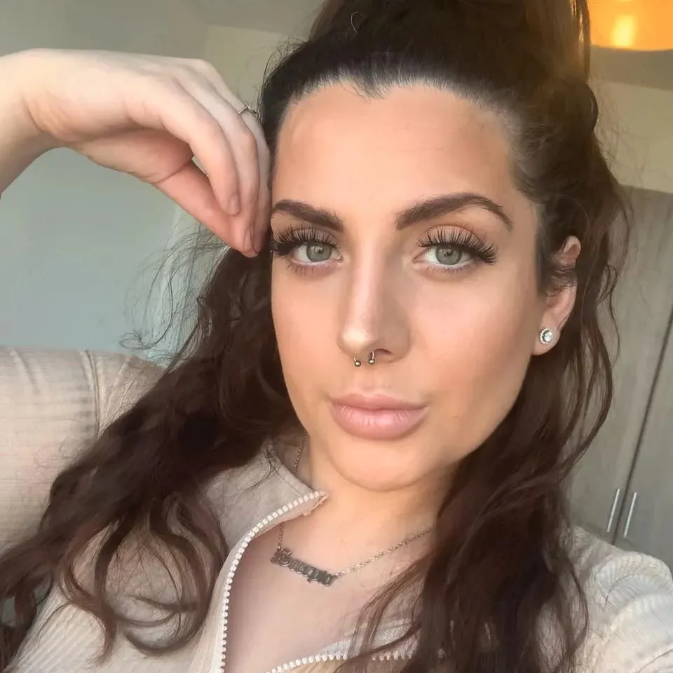 Headshot of Michelle Molver, a woman with long dark hair, light eyes, and a septum piercing.