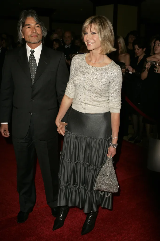 Patrick McDermott and Olivia Newton-John on a red carpet.