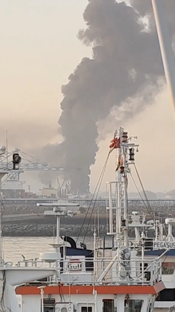 Smoke billows from the Fujairah oil industry zone following a drone attack.