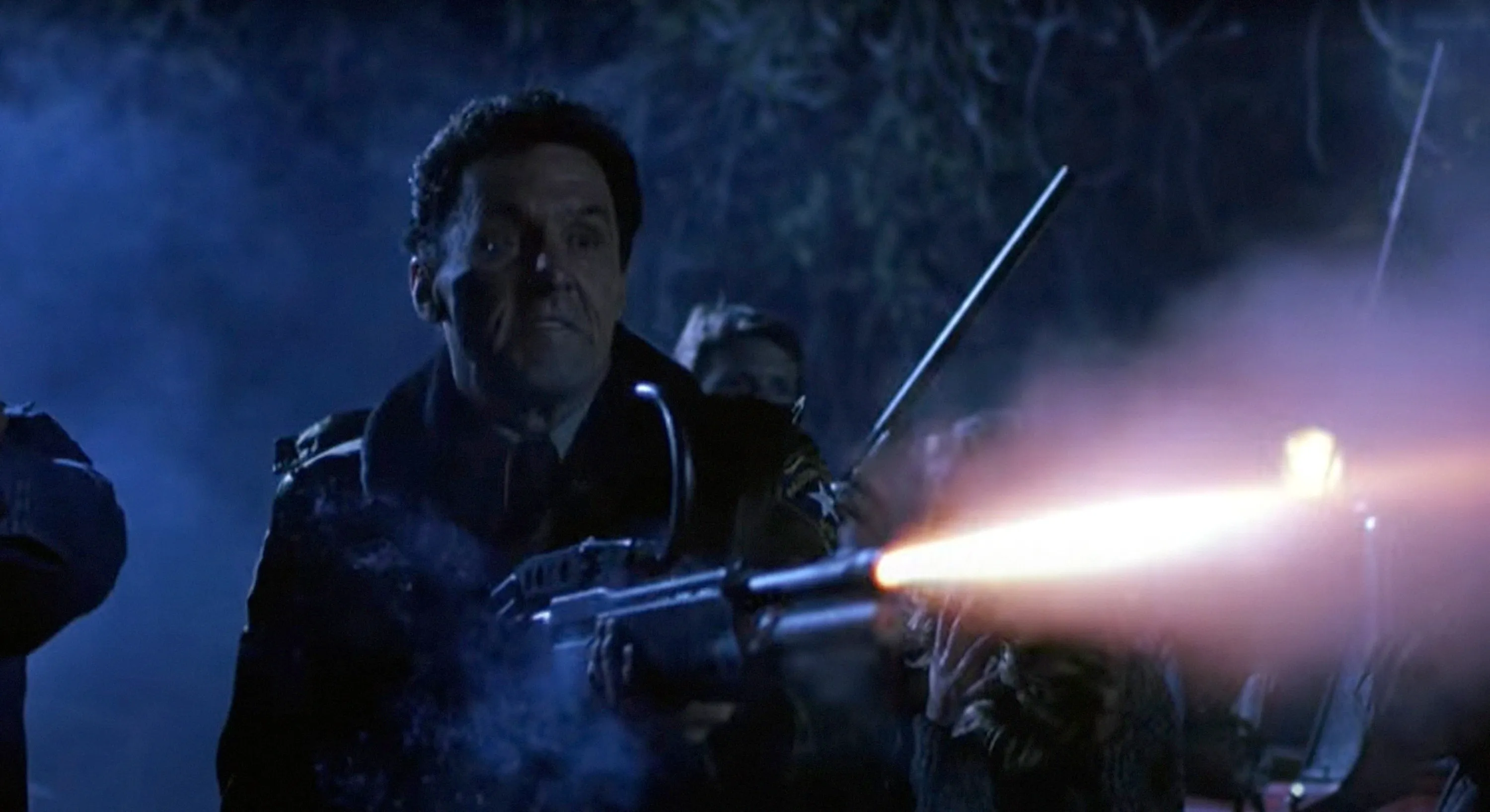 Beau Starr as Sheriff Ben Meeker firing a shotgun in a still from "Halloween 5: The Revenge of Michael Myers."