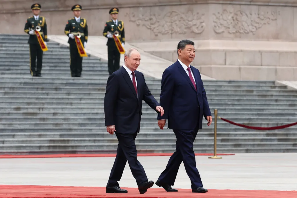 Russian President Vladimir Putin and Chinese President Xi Jinping walking side by side on a red carpet.