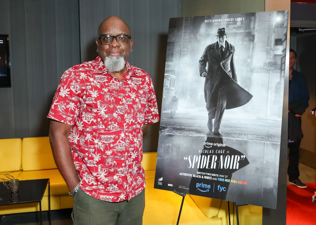 Warren Alan Young stands next to a "Spider-Noir" poster.