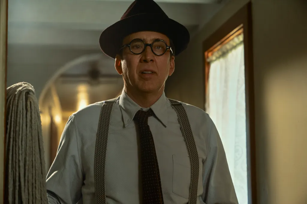 Nicolas Cage as Spider-Noir, wearing a hat, glasses, shirt, suspenders, and tie, in a still from the show.