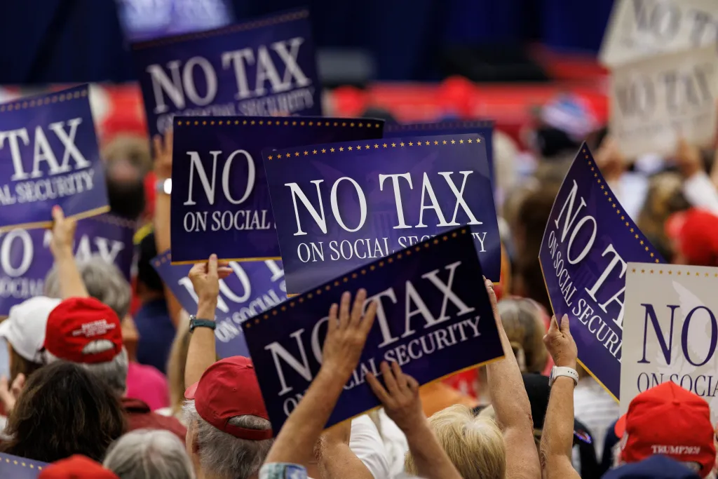 People holding up signs that say "NO TAX ON SOCIAL SECURITY".