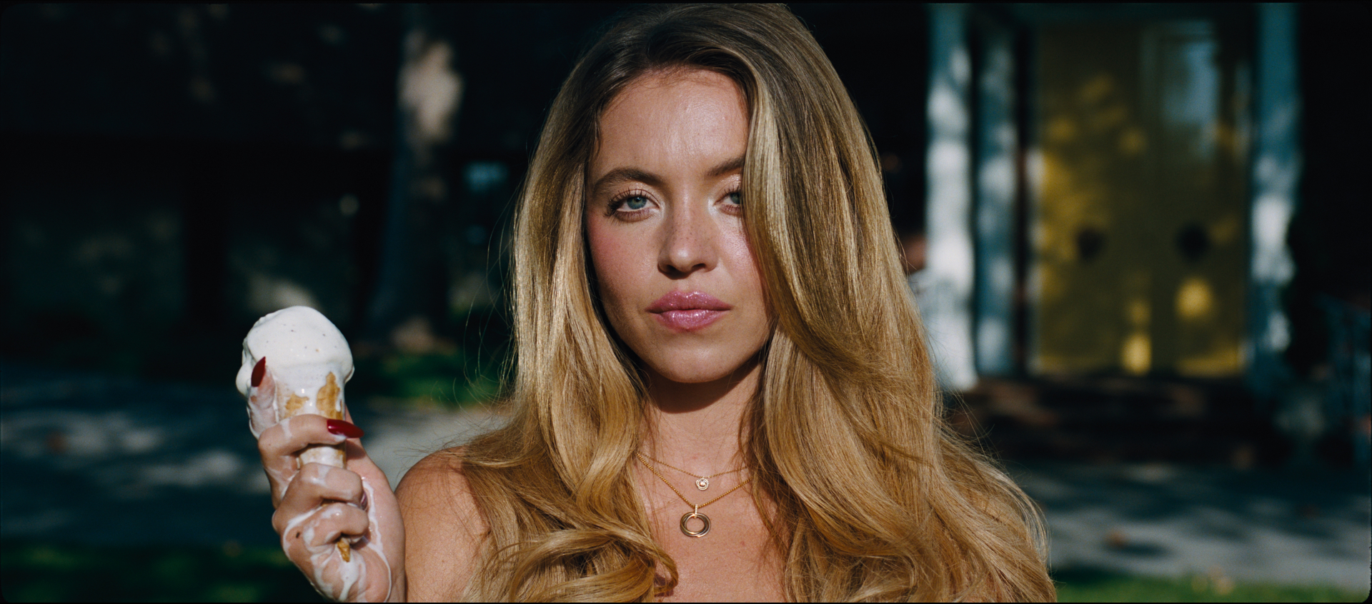 Sydney Sweeney as Cassie Howard holding a melting ice cream cone from the TV series Euphoria Season 3.
