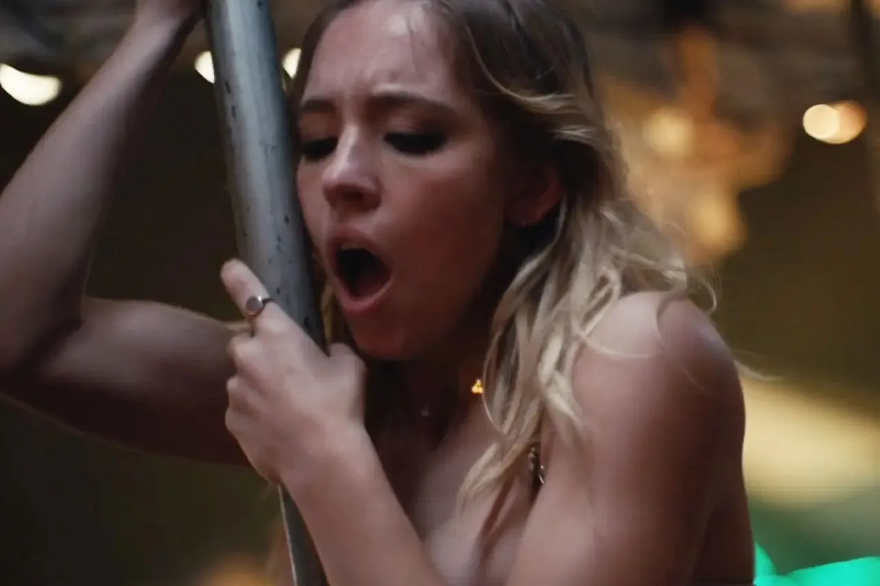 Cassie gripping a carousel pole with an open mouth expression in a still from "Euphoria."