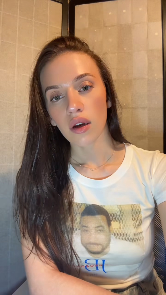 Tiana Krasniqi wearing a white T-shirt with a picture of James Broadnax on it.