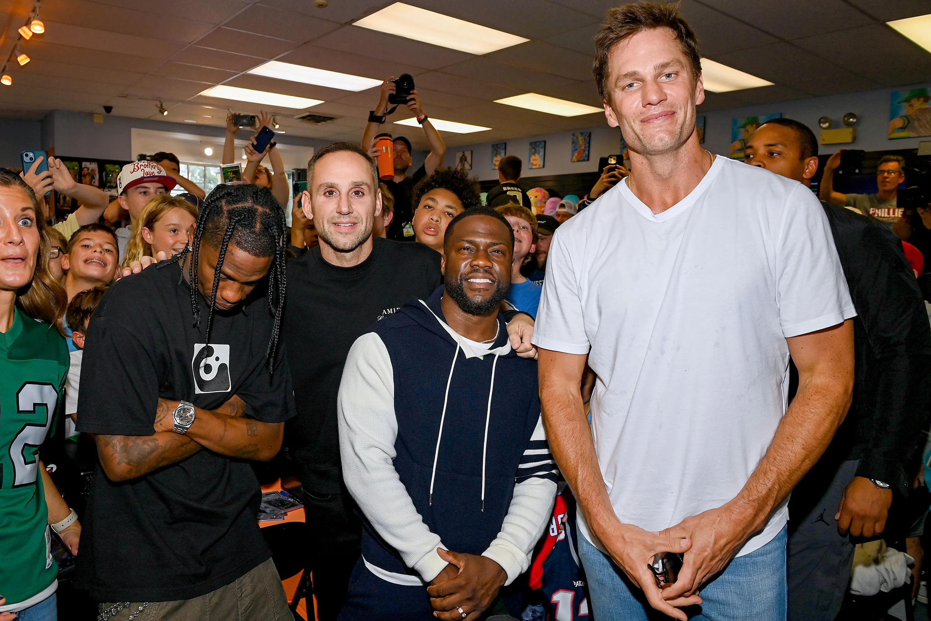 Travis Scott, Michael Rubin, Kevin Hart and Tom Brady at an event.