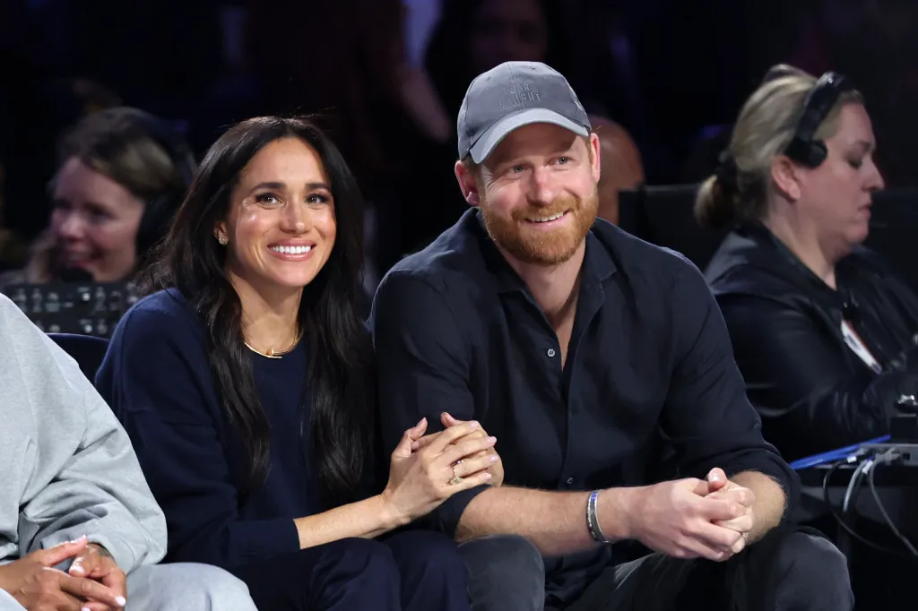 Meghan Markle and Prince Harry smiling at the 75th NBA All-Star Game.