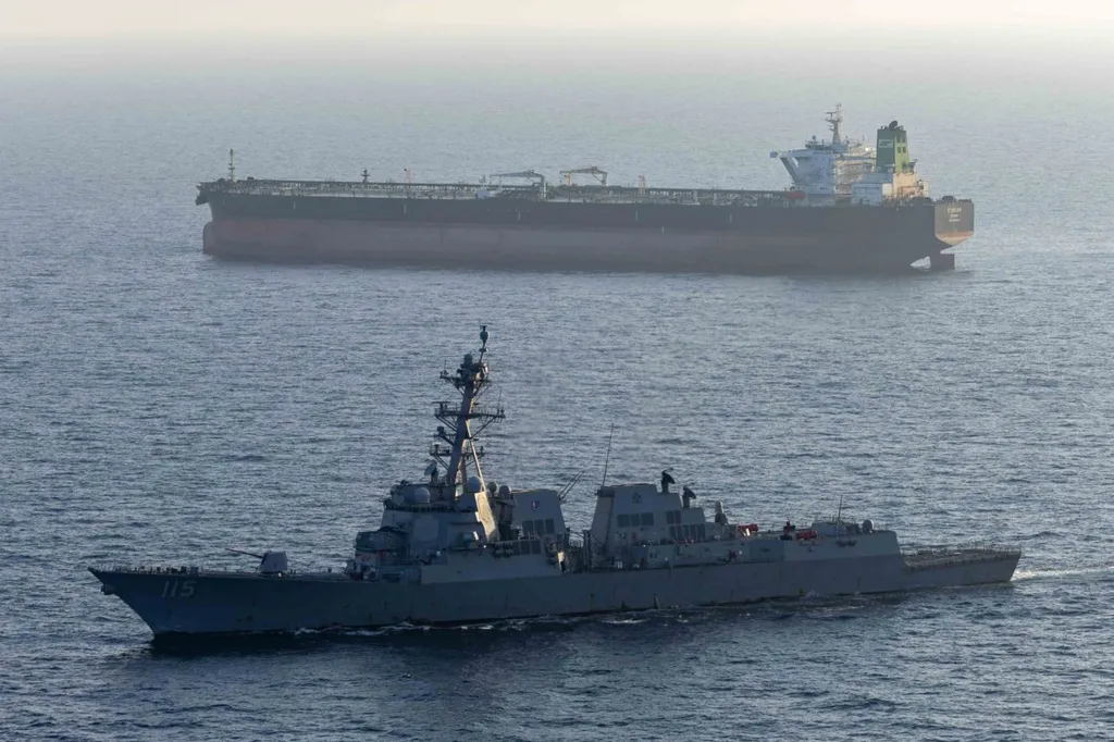 The US Navy guided-missile destroyer USS Rafael Peralta sailing in the foreground, with the M/T Stream tanker in the background.