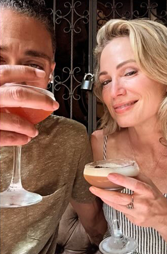 T.J. Holmes and Amy Robach toasting with cocktails.