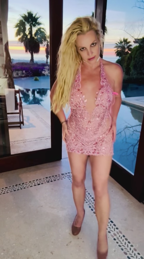 Britney Spears dancing in a pink mini-dress.