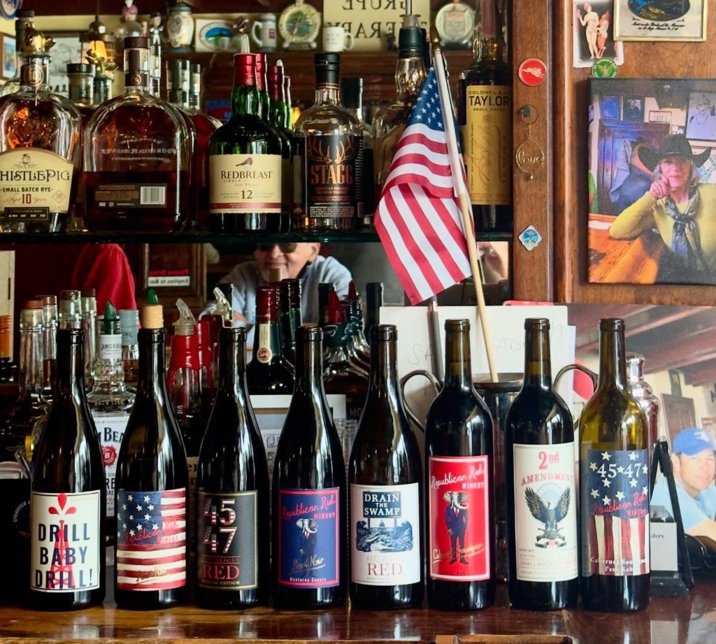 Bottles of wine from Republican Red Winery, featuring political themes such as "Drain the Swamp" and "Drill Baby Drill."