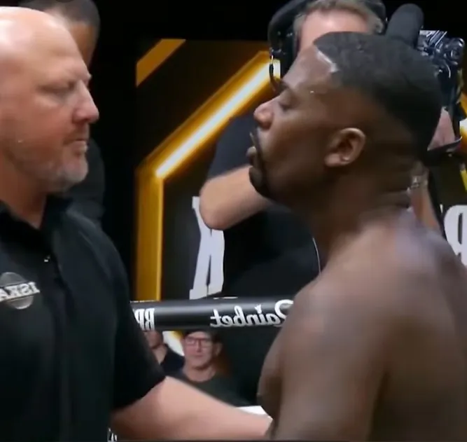 Ray J facing a boxing referee in the ring.