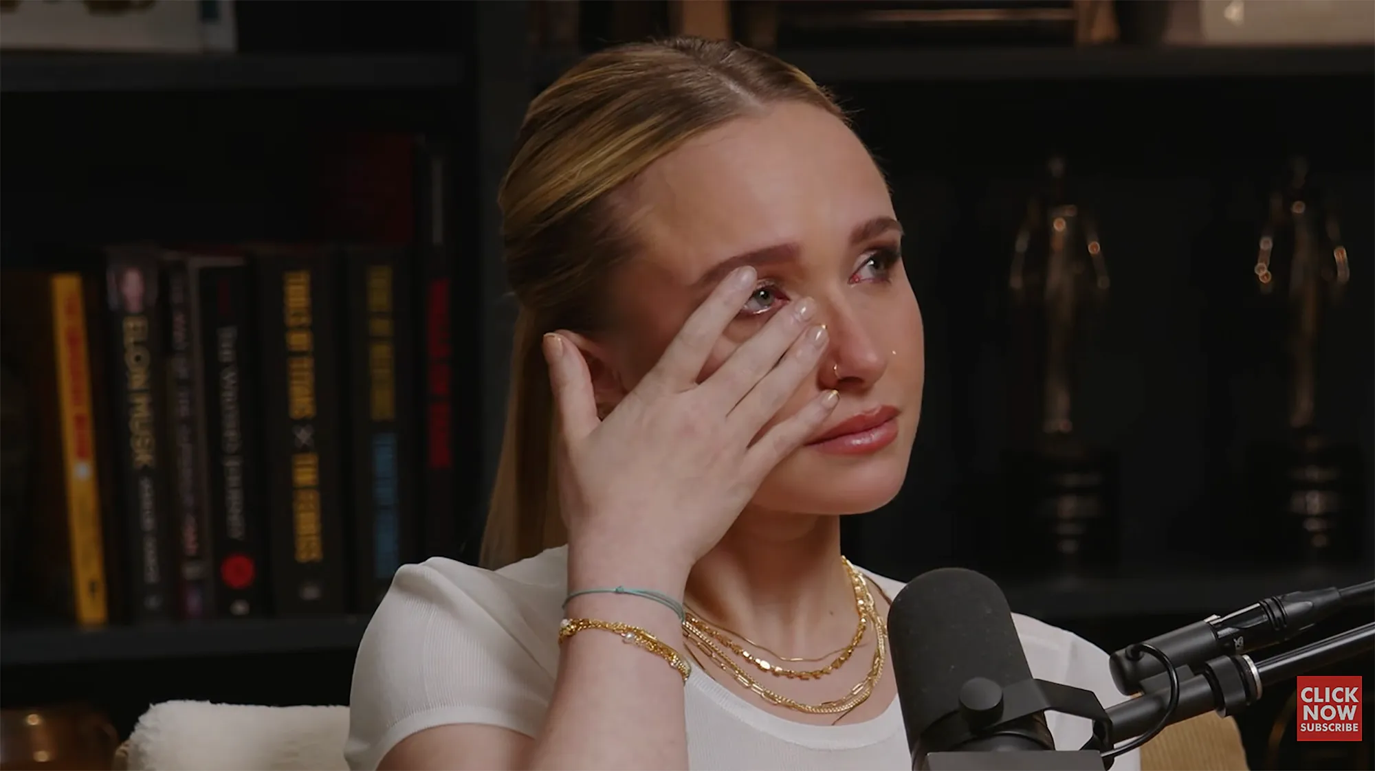 Hayden Panettiere wipes away tears during an interview.