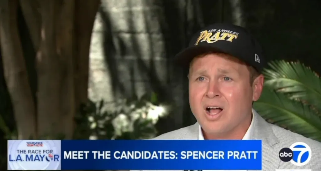 Spencer Pratt giving an interview on his homeless plan, with a lower-third graphic reading "MEET THE CANDIDATES: SPENCER PRATT".