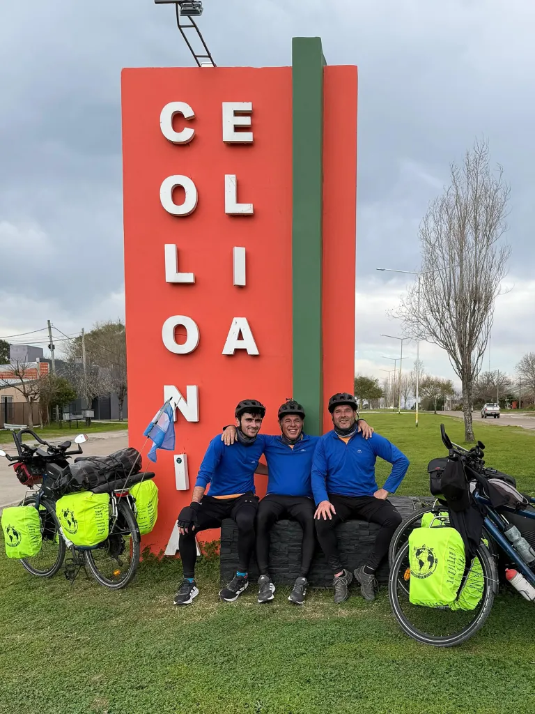 the friends stop to pose in front of a large orange sign