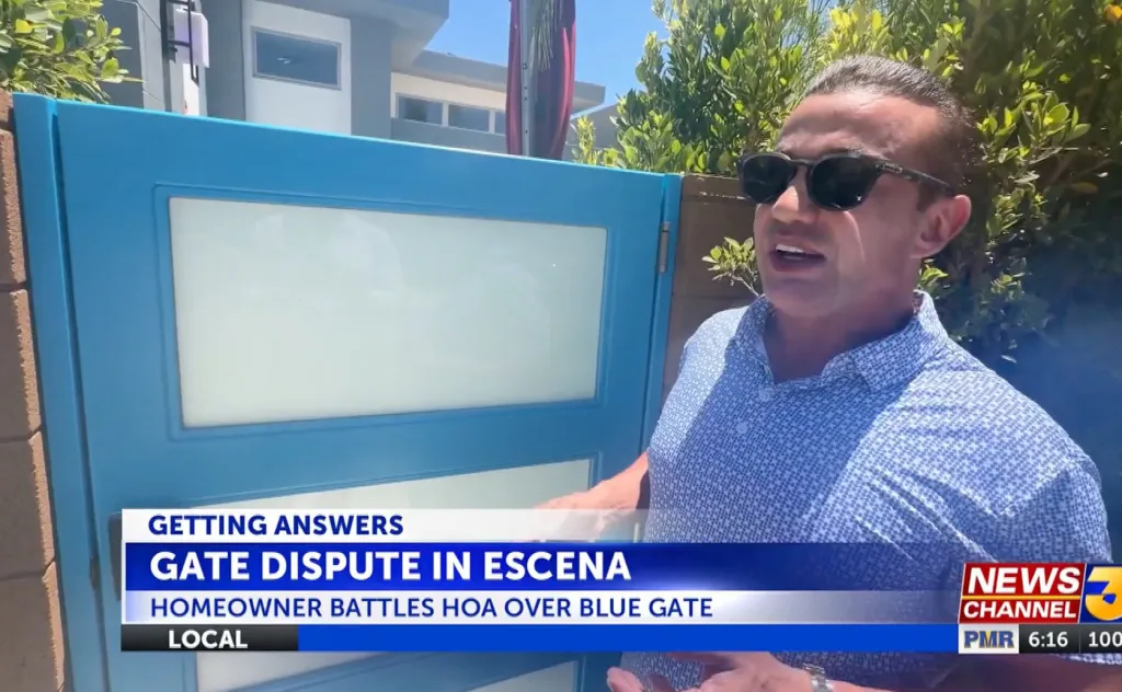 A man in sunglasses standing next to a blue gate, with news captions about a "Gate Dispute in Escena" and a "Homeowner Battles HOA Over Blue Gate."