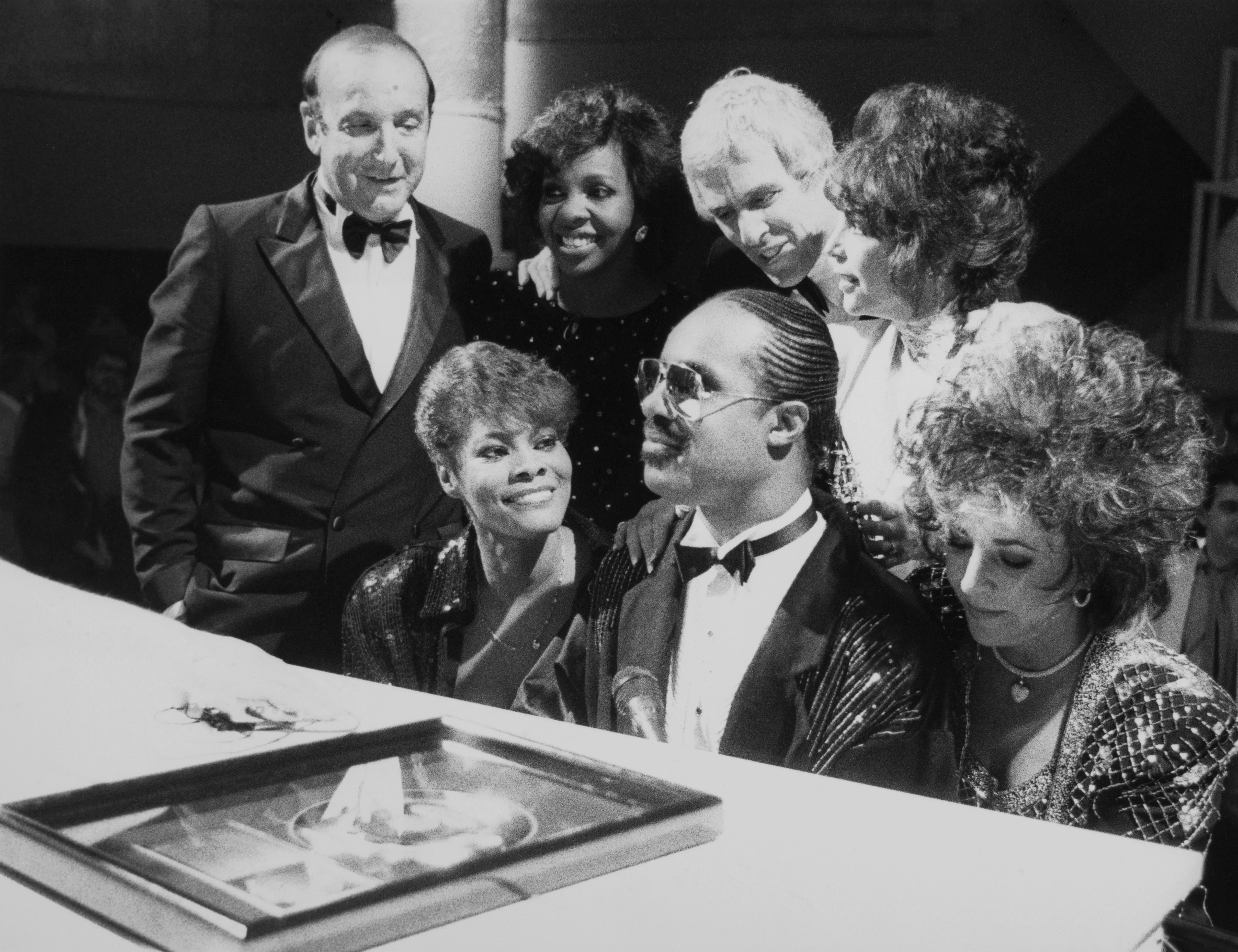 Clive Davis, Dionne Warwick, Stevie Wonder, Elizabeth Taylor, Gladys Knight, Burt Bacharach, and Carole Bayer Sager at a "Solid Gold" performance.