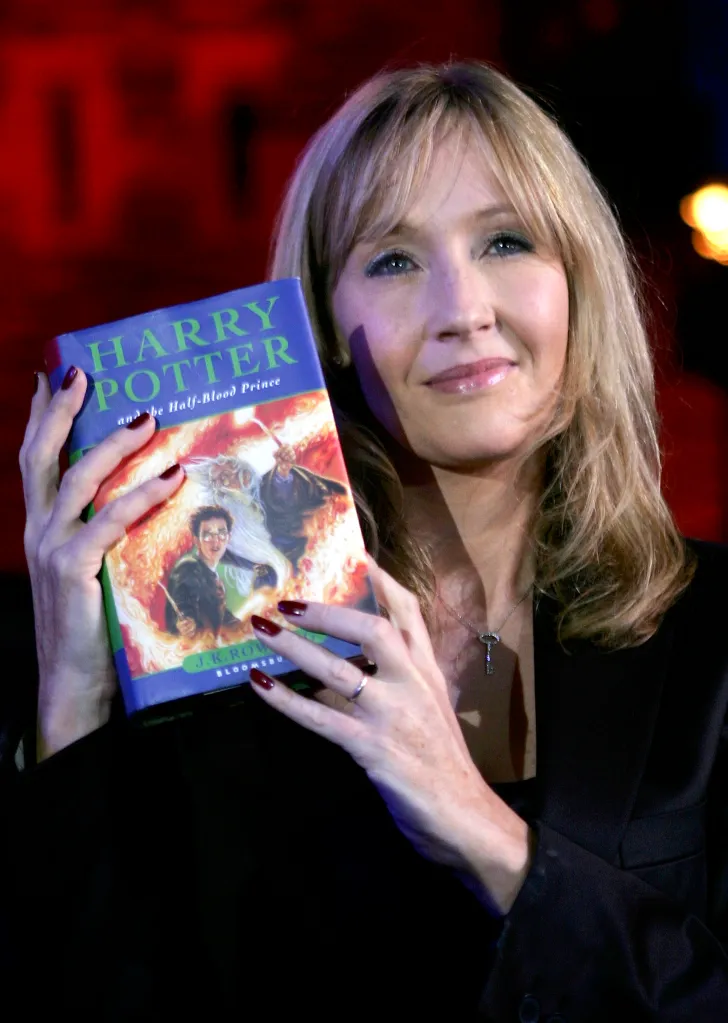 J.K. Rowling holding the "Harry Potter and the Half-Blood Prince" book.