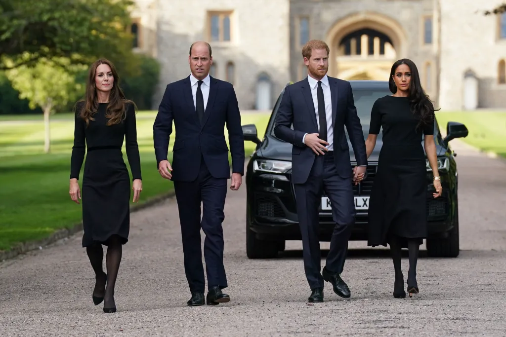 Catherine, Princess of Wales, Prince William, Prince of Wales, Prince Harry, Duke of Sussex, and Meghan, Duchess of Sussex walking together outside Windsor Castle.