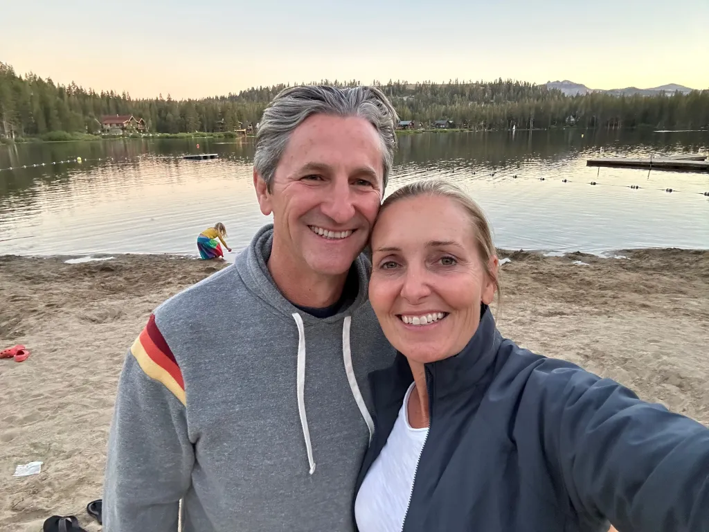Amy Hillyard, a missing person, smiling next to a man on a beach.