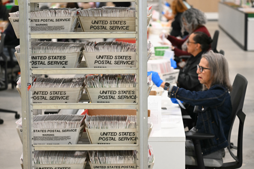 Election workers process ballots at the Los Angeles County Ballot Processing Center.