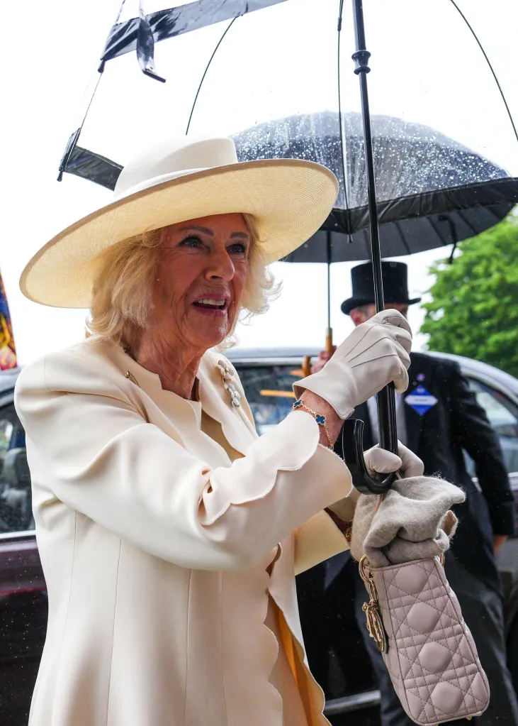 Queen Camilla holding a clear umbrella at the Epsom Derby.